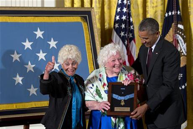 President Barack Obama posthumously bestows the Medal Of Honor for Army Sgt. William Shemin to his daughters Ina Bass, left, and Elsie Shemin-Roth, of suburban St. Louis, during a ceremony in the East Room of the White House in Washington, Tuesday, June 2, 2015.  (AP Photo/Carolyn Kaster)