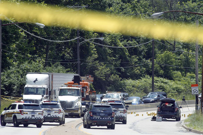 Emergency vehicles block the road along Route 51 at an area marked off as a crime scene in the Pittsburgh's Beltzhoover section on Monday, June 22, 2015. (AP Photo/Keith Srakocic) 