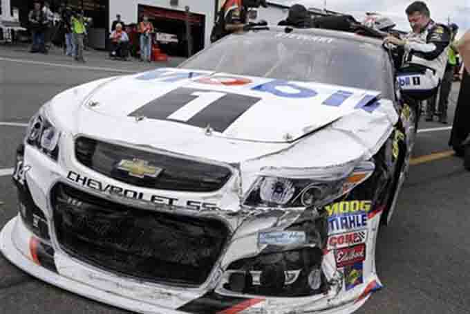 In this Friday, June 5, 2015, file photo, driver Tony Stewart climbs from his damaged race car in the garage area after hitting the wall at Pocono Raceway during practice for the NASCAR Sprint Cup Series auto race in Long Pond, Pa. Stewart is still winless during a trying 2015 season. (AP Photo/Mel Evans, File)