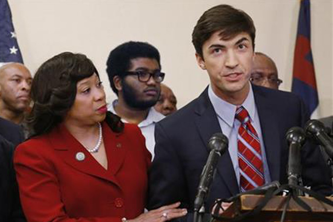 In this March 25, 2015 file photo, Oklahoma state Sen. Anastasia Pittman, left, D-Oklahoma City, stands with Levi Pettit, right, a former University of Oklahoma fraternity member caught on video leading a racist chant, during a news conference at Fairview Baptist Church in Oklahoma City. Pettit apologized for the chant. Sigma Alpha Epsilon, the fraternity connected to the racist video, has announced the hiring of a diversity director who will be charged with helping the fraternity’s chapters across the nation become more inclusive. (AP Photo/Sue Ogrocki, File)