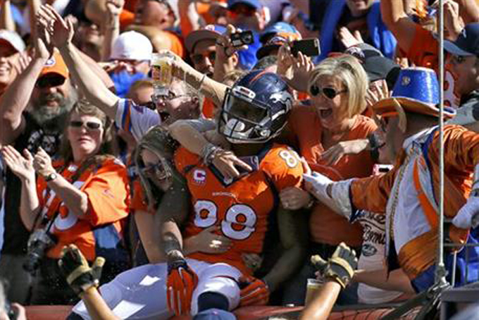 In this Oct. 5, 2014, file photo, Denver Broncos wide receiver Demaryius Thomas (88) celebrates his touchdown against the Arizona Cardinals with fans during the first half of an NFL football game in Denver.  (AP Photo/Jack Dempsey, File)