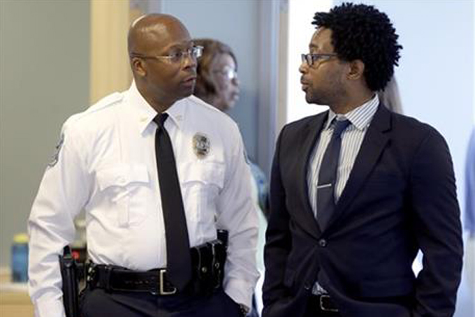 Andre Anderson speaks with Ferguson City Council member Wesley Bell, right, after being introduced as the the interim chief of the Ferguson Police Department during a news conference Wednesday, July 22, 2015, in Ferguson, Mo. Anderson becomes the second interim chief since Police Chief Thomas Jackson stepped down in March. (AP Photo/Jeff Roberson)