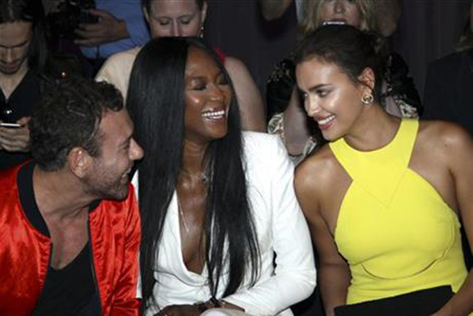 British born model Naomi Campbell, center, and Russian model Irina Shayk, right, attend Versace's fall-winter 2015/2016 Haute Couture fashion collection presented in Paris, France, Sunday, July 5, 2015. (AP Photo/Thibault Camus)