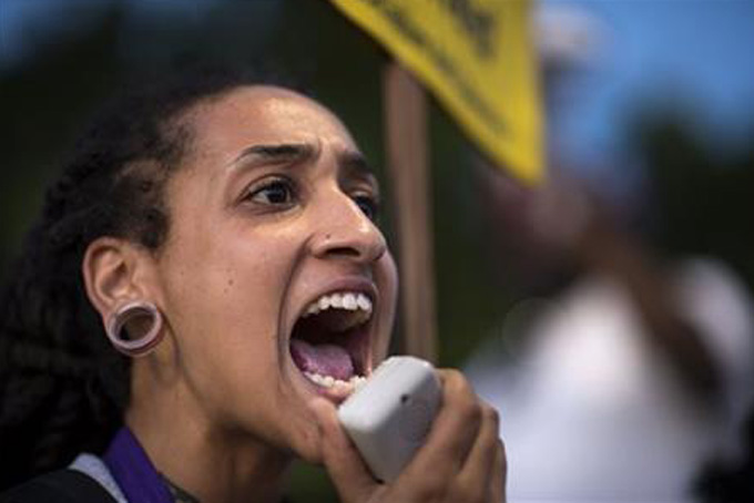 In this April 29, 2015, photo, Maile Hampton leads a group in a chant as they protest the death of Freddie Gray in Sacramento, Calif. (Hector Amezcua/The Sacramento Bee via AP) 