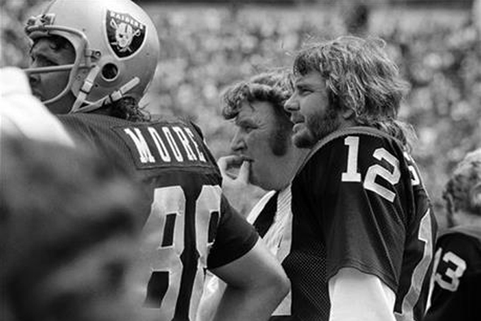 FILE - In this Aug. 25, 1975, file photo, Oakland Raiders coach John Madden, center, and quarterback Ken Stabler watch the team's NFL football game against the Pittsburgh Steelers in Oakland, Calif. Stabler, who led the Raiders to a Super Bowl victory and was the NFL's Most Valuable Player in 1974, has died as a result of complications from colon cancer. He was 69. His family announced his death on Stabler's Facebook page on Thursday, July 9, 2015. (AP Photo/File)