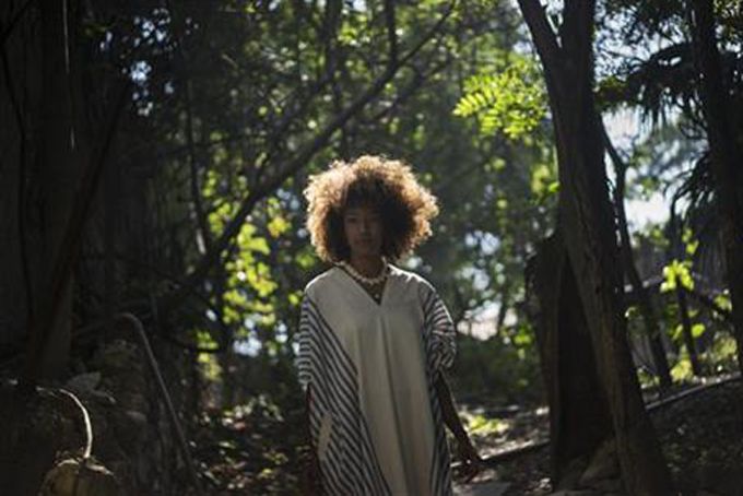 In this June 5, 2015 photo, Juliana Luna, 29, poses for a photo, in Rio de Janeiro, Brazil. The 29-year-old website entrepreneur was among dozens of Brazilians chosen for a recent documentary project that used DNA samples to trace ancestral connections to Africa. Luna traced her roots to Nigeria, where she was taken by the project to visit a slave port near Lagos. (AP Photo/Felipe Dana)