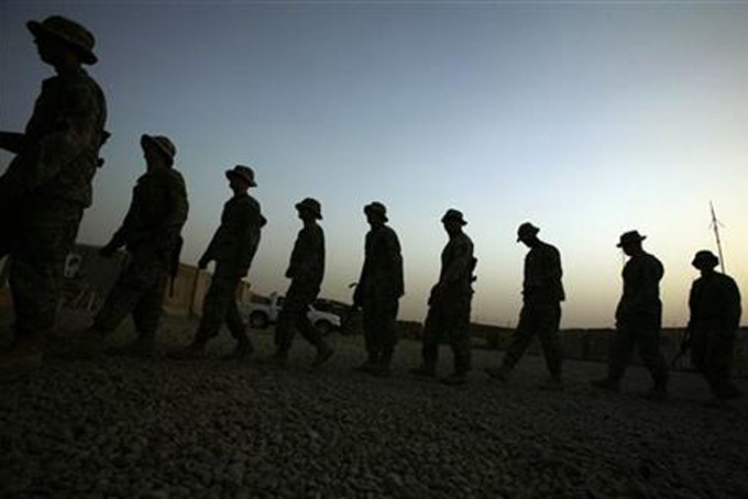 In this June 29, 2009 file photo, U.S. Army soldiers walk in a line at a reenlistment ceremony for a comrade in Baqouba, Iraq. New research published Wednesday, July 8, 2015 in JAMA Psychiatry shows war-time suicide attempts in the Army are most common in early-career enlisted soldiers who have not been deployed, while officers are less likely to try to end their lives. The study looked at data on nearly 1,000 suicide attempts among almost 1 million active-duty Army members during the wars in Afghanistan and Iraq, from 2004 to 2009. (AP Photo/Maya Alleruzzo, File)
