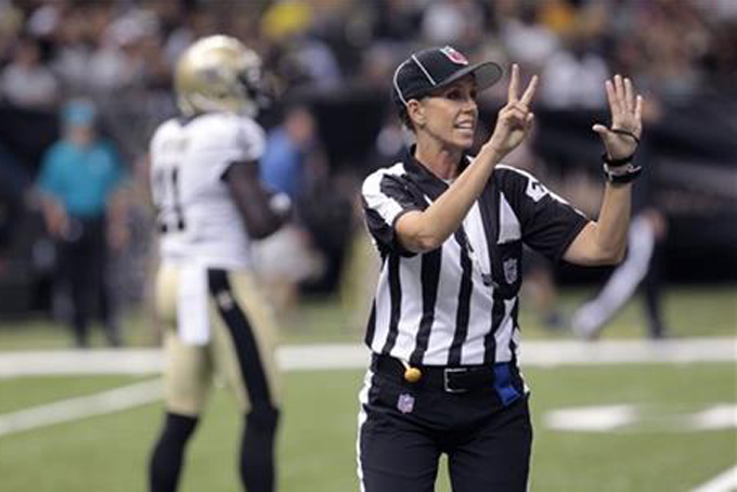 FILE - In this Aug. 16, 2013, file photo, NFL referee Sarah Thomas works the game in the second half of an NFL preseason football game between the New Orleans Saints and the Oakland Raiders at the Mercedes-Benz Superdome in New Orleans. Sarah Thomas is that much closer to taking the field as the NFL's first female official. She's part of a clinic for all refs with most training camps about two weeks away from opening. (AP Photo/Matthew Hinton, File)