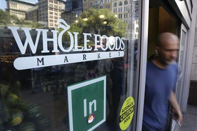 FILE - In this June 24, 2015, file photo, a shopper leaves the Whole Foods Market store in New York's Union Square. Whole Foods reports quarterly financial results on Wednesday, July 29, 2015. (AP Photo/Julie Jacobson, File)