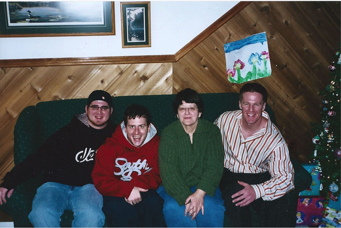 At their family home in Mundys Corner, the Snyder brothers, Josh, Todd and Jason (left to right), pose with their mother, Melissa, around Christmas in 2004, a few weeks before Todd’s overdose. (Photo courtesy of Jason Snyder)