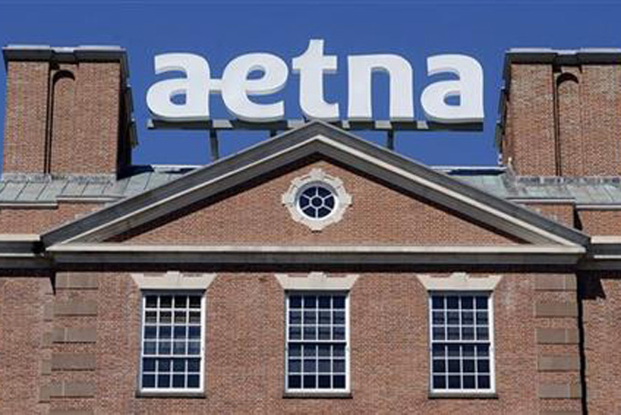 FILE - In this Tuesday, Aug. 19, 2014, file photo, a sign for Aetna Inc., sits atop a building at the company headquarters in in Hartford, Conn. Health insurer Aetna Inc. has made a deal to buy competitor Humana Inc. in a $37 billion deal the companies say would create the second-largest managed care company, it was announced Friday, July 3, 2014. (AP Photo/Jessica Hill, File)