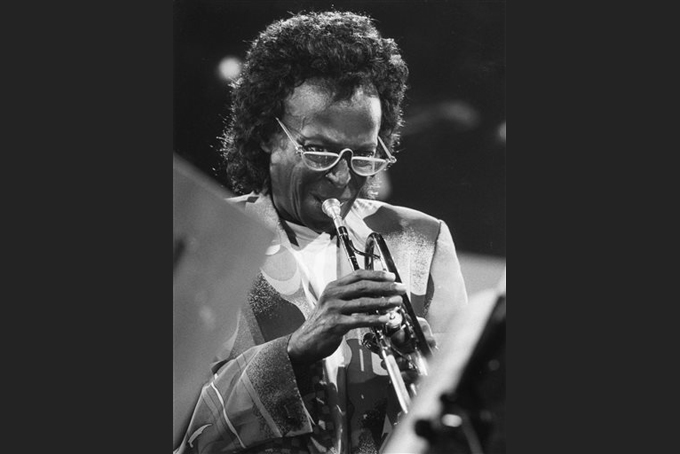 IIn this July 8, 1991 file photo, Miles Davis performs at the Jazz-Festival in Montreaux, Switzerland.  Davis appeared for the first time at the Newport Jazz Festival in 1955 and gave a career-reviving performance. This year's program book is Miles-centric as the festival, which begins July 31 at Fort Adams State Park, celebrates the 60th anniversary of the jazz legend's historic Newport debut.  (Keystone via AP, File)