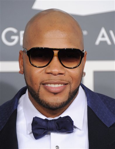 Flo Rida arrives at the 55th annual Grammy Awards on Sunday, Feb. 10, 2013, in Los Angeles.  (Photo by Jordan Strauss/Invision/AP)