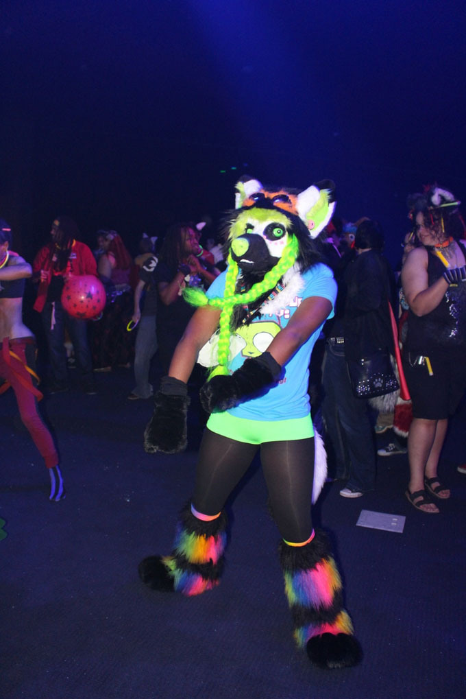 A young African American woman dances in a partial suit at the Anthrocon Rave dance party in July 2014. (Photo by J.L. Martello/File)
