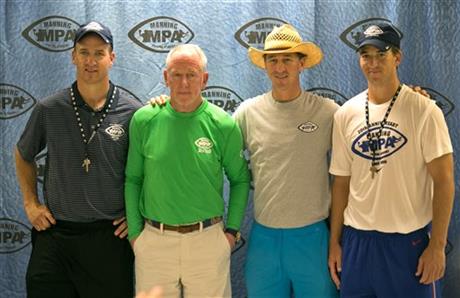 In this photo taken on Friday, July 10, 2015, the Manning Family, from left to right, Peyton, Archie, Cooper and Eli pose for a group photo before they talk to the media about the Manning Passing Academy at Nicholls State University in Thibodaux, La. About 1,200 aspiring quarterbacks, receivers, running backs and tight ends practice and learn football fundamentals from the Mannings. The 20th annual camp runs from July 9-12 at Nicholls State University with the perennial leaders - former New Orleans Saints quarterback Archie Manning and his three sons, Super Bowl winners Peyton, and Eli and Cooper. (Ted Jackson/NOLA.com The Times-Picayune via AP) 