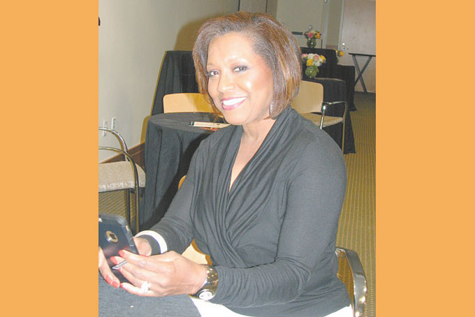 TAKING CARE OF BUSINESS—No matter what event Ola Jackson, owner of OWN attends she always is prepared to take care of business. (Photo by Diane I. Daniels)