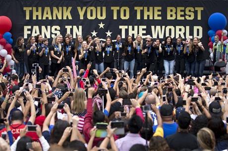 Members of the U.S. women's soccer team and fans celebrate the team's World Cup championship during a public celebration, Tuesday, July 7, 2015, in Los Angeles. This was the first U.S. stop for the team since beating Japan in the Women's World Cup final Sunday in Canada. (AP Photo/Jae C. Hong)