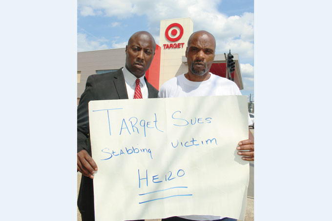 SUED FOR HEROISM—Michael Turner, right, with his attorney Todd Hollis. (Photo by J.L. Martello)