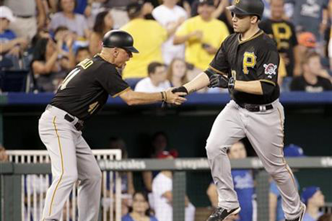 Pittsburgh Pirates' Travis Ishikawa, right, celebrates with third base coach Rick Sofield after hitting a two-run home run during the fifth inning of a baseball game Monday, July 20, 2015, in Kansas City, Mo. (AP Photo/Charlie Riedel)