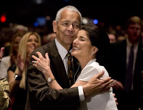 FILE- In this April 10, 2014, file photo, social activist Julian Bond hugs Luci Baines Johnson, the younger daughter of President Lyndon Baines Johnson after singing "We Shall Overcome" during the Civil Rights Summit to commemorate the 50th anniversary of the signing of the Civil Rights Act in Austin, Texas. Bond, a civil rights activist and longtime board chairman of the NAACP, died Saturday, Aug. 15, 2015, according to the Southern Poverty Law Center. He was 75. (AP Photo/Carolyn Kaster File)