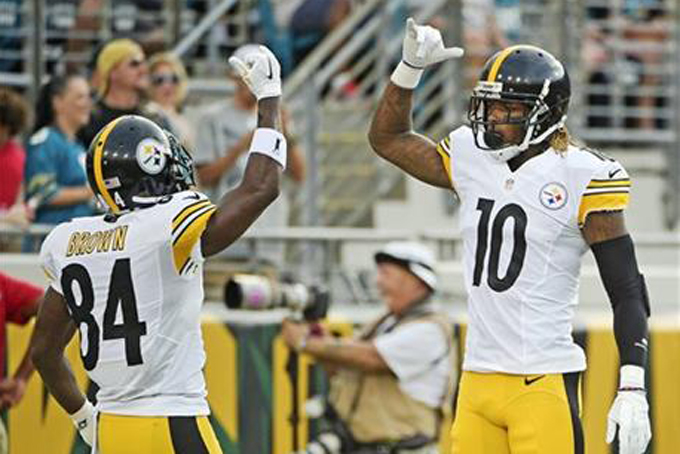 Pittsburgh Steelers wide receiver Antonio Brown, left, gives a high five to wide receiver Martavis Bryant, right, after Bryant caught a pass against the Jacksonville Jaguars for a 44-yard touchdown during the first half of an NFL preseason football game, Friday, Aug. 14, 2015, in Jacksonville, Fla. (AP Photo/Phelan M. Ebenhack)