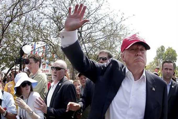 Republican presidential candidate Donald Trump waves to the crowd at the Iowa State Fair Saturday, Aug. 15, 2015, in Des Moines. (AP Photo/Charlie Riedel)