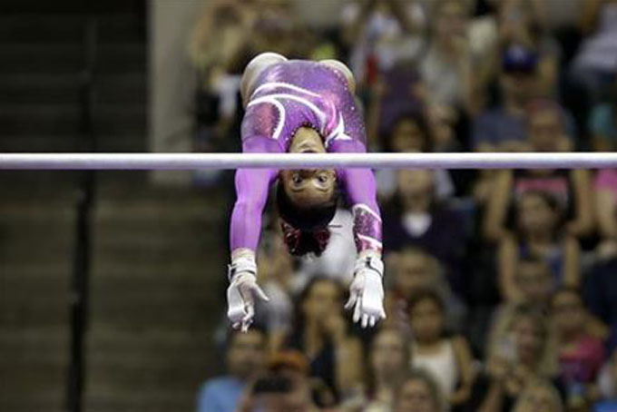 Gabrielle Douglas competes on the uneven bars at the U.S. women's gymnastic championships Saturday, Aug. 15, 2015, in Indianapolis. (AP Photo/AJ Mast)