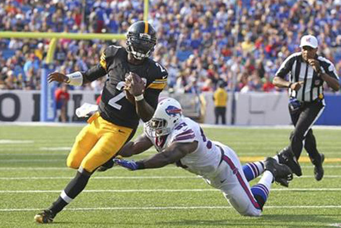 Pittsburgh Steelers quarterback Michael Vick (2) is pursued by Buffalo Bills defensive tackle Corbin Bryant (97) during the first half of a preseason NFL football game on Saturday, Aug. 29, 2015, in Orchard Park, N.Y. (AP Photo/Bill Wippert)