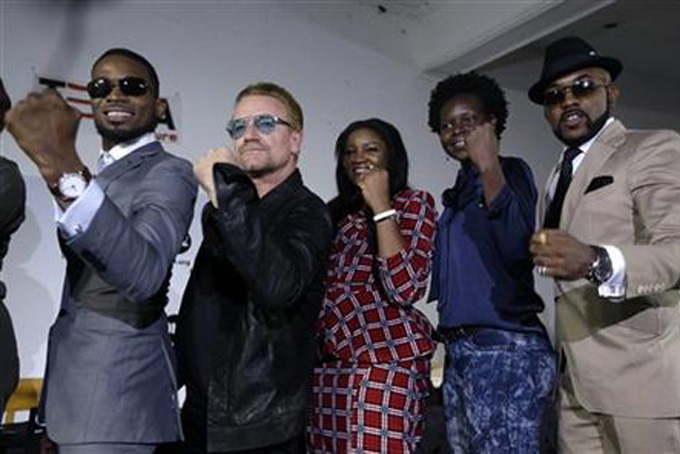 Irish rock star Bono, second left, poses with African music stars after a press conference in Lagos, Nigeria, Friday, Aug. 28, 2015,(AP Photo/Sunday Alamba)