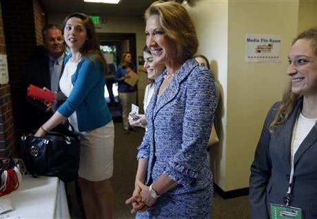 Republican presidential candidate, businesswoman Carly Fiorina, arrives for a forum for most of the major Republican candidates, Monday, Aug. 3, 2015, in Manchester, N.H. The Republican Party's jam-packed presidential class faces off Monday night in New Hampshire, where more than a dozen White House hopefuls aim to warm up for the first full-fledged debate of the primary season. (AP Photo/Jim Cole)
