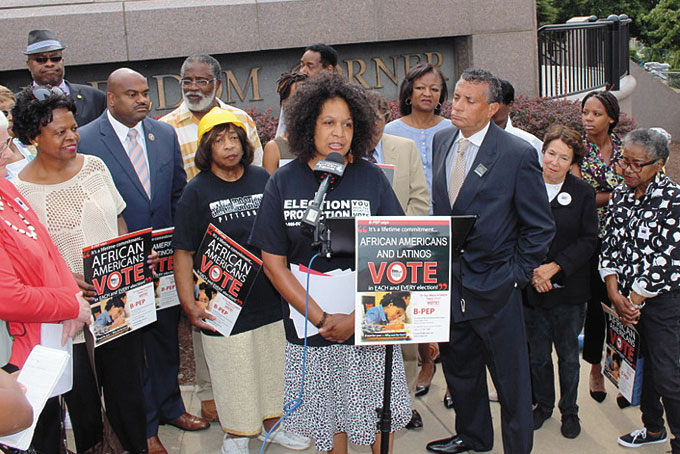 CONTINUING THE FIGHT—Celeste Taylor calls on supporters to continue the battle against voter suppression during the 50th anniversary celebration of the Voting Rights Act at Freedom Corner. (Photo by J.L. Martello)