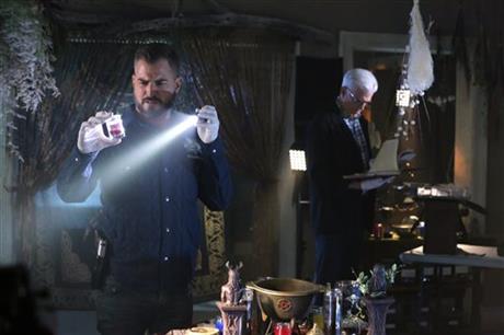 In this image released by CBS, George Eads, left, and Ted Danson appear in a scene from "CSI: Crime Scene Investigation." "CSI," which debuted in 2000, will wrap with a two-hour finale on Sept. 27. Original cast members including William Petersen and Marg Helgenberger are returning for the send-off. (Michael Yarish/CBS via AP)