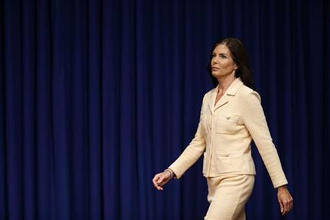 Pennsylvania Attorney General Kathleen Kane arrives for a news conference, Wednesday, Aug. 12, 2015, at the state Capitol in Harrisburg, Pa. Kane said that criminal charges threatening to end her career were filed as part of an effort by state prosecutors and judges to conceal pornographic and racially insensitive emails they circulated with one another. Kane was charged last week with leaking grand jury information to a newspaper reporter as payback to a former state prosecutor and then lying about it under oath. (AP Photo/Matt Rourke)