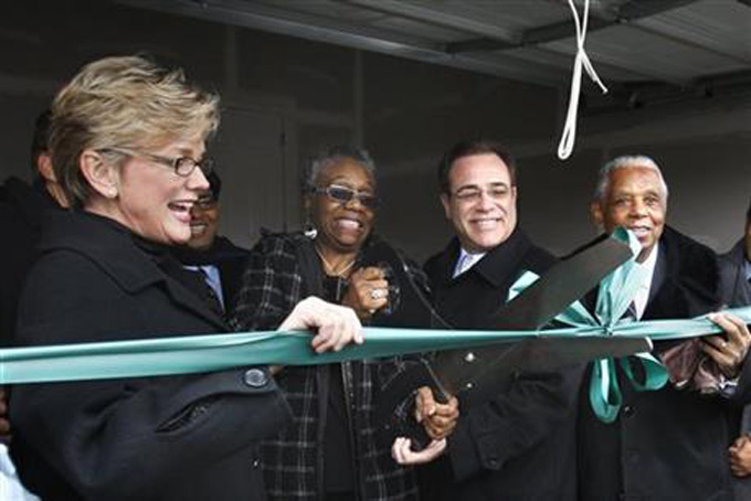 In a Jan. 18, 2010 file photo, Sallie Sanders, second from left, is helped by, from left, Michigan Gov. Jennifer Granholm, Wayne County Executive Robert Ficano and Judge Damon Keith, with a ribbon cutting outside her new house in Hamtramck, Mich., near Detroit. Keith, now 93, has ordered taxpayers in Hamtramck to pay up as a way to end a housing discrimination case that has been in federal court for more than 40 years. (AP Photo/Carlos Osorio, File)