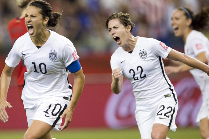 United States' Carli Lloyd (10) reacts after scoring on a penalty kick against Germany as Meghan Klingenberg (22) follows during the second half of a semifinal in the Women's World Cup soccer tournament, Tuesday, June 30, 2015, in Montreal, Canada. (Ryan Remiorz/The Canadian Press via AP)