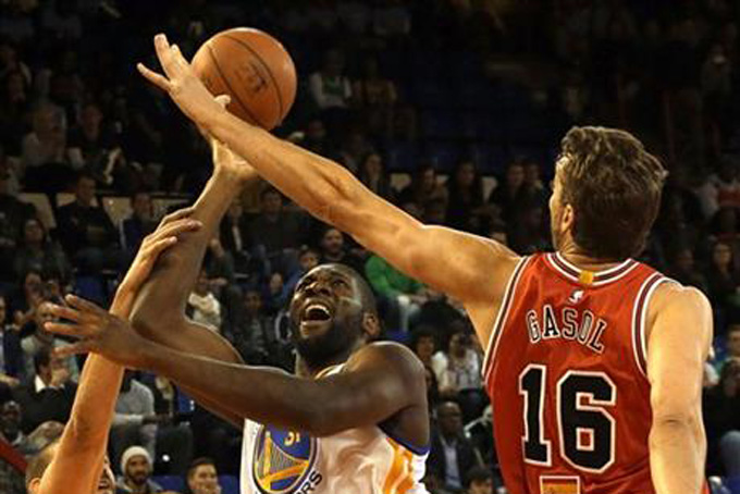 Team Africa's Festus Ezeli, center, attempts a hook shot as Team World's Paul Gasol, right, defends during the NBA Africa Game at Ellis Park Arena in Johannesburg, South Africa, Saturday, Aug. 1, 2015. (AP Photo/Themba Hadebe)
