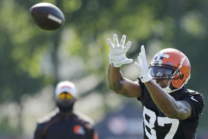 Cleveland Browns wide receiver Terrelle Pryor catches a pass during practice at the NFL football team's training camp Thursday, July 30, 2015, in Berea, Ohio. Pryor has been a quarterback his entire football life, but the gifted athlete is swtiching positions at the highest level, trying to win a roster spot as a wide receiver for the Cleveland Browns. He's impressive in pads, but the Browns need him to do more than look good in his uniform. (AP Photo/Tony Dejak)