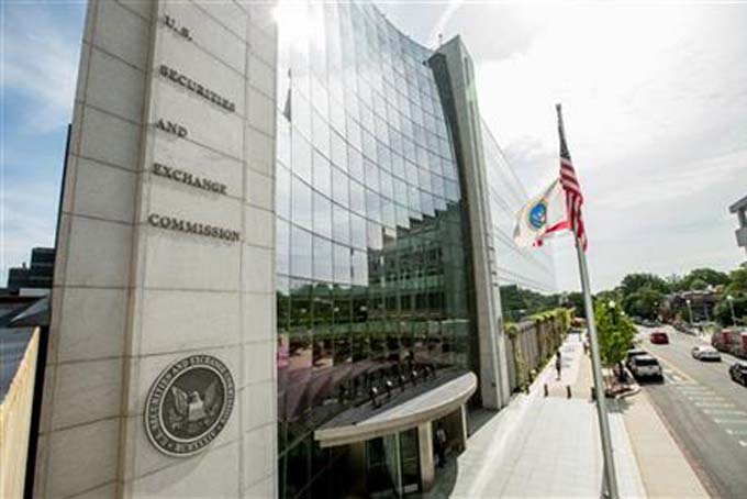 This June 19, 2015 photo shows the U.S. Securities and Exchange Commission building, in Washington. The Securities and Exchange Commission is scheduled to vote Wednesday, Aug. 5, 2015, to formally adopt a rule compelling public companies to report the ratio between their chief executive's annual compensation and the median, or midpoint, pay of employees. (AP Photo/Andrew Harnik)
