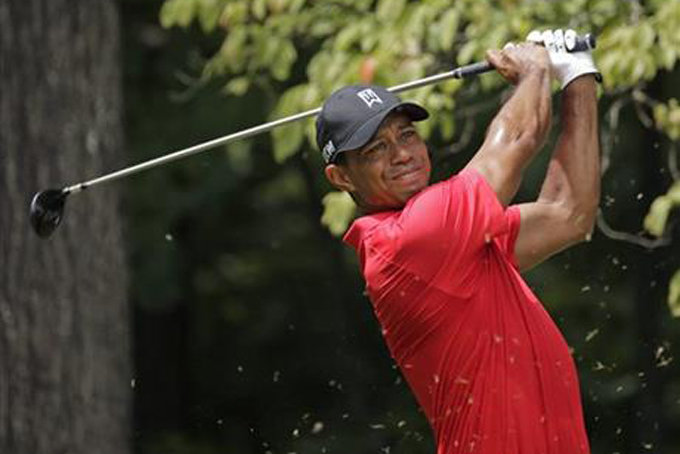 Tiger Woods watches his tee shot on the second hole during the final round of the Wyndham Championship golf tournament at Sedgefield Country Club in Greensboro, N.C., Sunday, Aug. 23, 2015. (AP Photo/Chuck Burton)