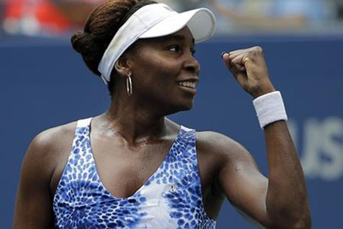 Venus Williams, of the United States, reacts to her coach's box after defeating Belinda Bencic, of Switzerland, during the third round of the U.S. Open tennis tournament, Friday, Sept. 4, 2015, in New York. (AP Photo/Matt Rourke)