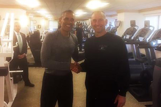 In this photo provided by the Boston Red Sox, President Barack Obama, left, shakes hands with Boston Red Sox Interim Manager Torey Lovullo in the exercise room of the New York Palace Hotel, Tuesday, Sept. 29, 2015, in New York. (Mike Hazen/Boston Red Sox via AP) MANDATORY CREDIT