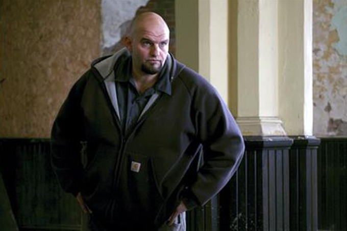 FILE -- In this March 9, 2007 file photo, Braddock Mayor John Fetterman oversees volunteers working in the former United Brethren in Christ Church in Braddock, Pa. Fetterman said Friday, Sept. 11, 2015 that he'll run for the Democratic nomination for Republican Pat Toomey's U.S. Senate seat in 2016. (AP Photo/Andrew Rush)