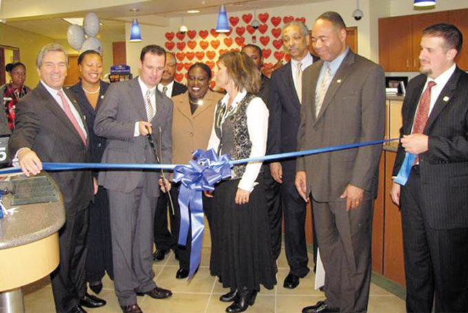 GRAND OPENING—Pittsburgh Mayor Luke Ravenstahl, prepares for the ribbon cutting at the new Fifth third Bank branch in the Hill District. Joining him, from left: James M. Ferguson III, Jada Grandy, Lloyd Wright, Tonya Payne, Jill Sandilla, Mark Jones, Will Moode, Ralph Parks and Norman Marraccini.
