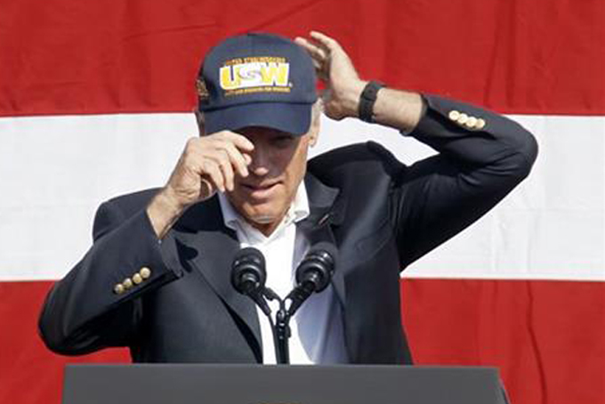 Vice President Joe Biden puts on a United Steelworkers hat before he spoke to a crowd before he joined in the annual Labor Day parade on Monday, Sept. 7, 2015, in Pittsburgh. (AP Photo/Keith Srakocic)