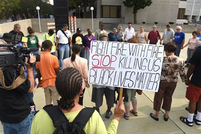 In this Friday, Aug. 28, 2015 photo, dozens of people gather during a rally outside the Frank Murphy Hall of Justice in Detroit regarding the shooting death of Terrance Kellom by an U.S. Immigration and Customs Enforcement (ICE) officer in April 2015. As the Black Lives Matter movement gains more public attention, there are questions being raised about who’s in charge of the movement and what its long-term goals are. (Max Ortiz/The Detroit News via AP)