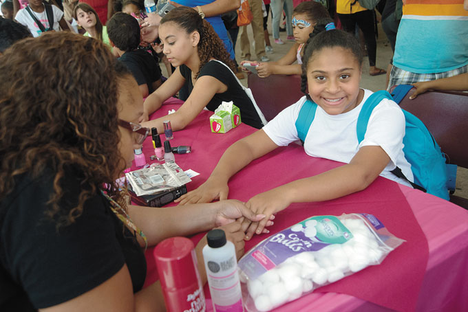 GETTING THEIR NAILS DONE—Nail technician Crystal Rose puts the finishing touches on 9-year-old Aijah Milner’s nails. Janiris Vazquez, 15, also got her nails done as part of the Back to School Fair at MLK School.
