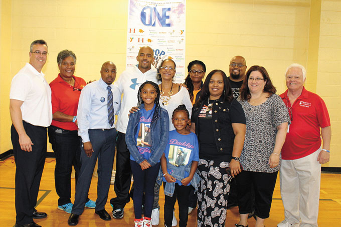 IN IT TOGETHER—Representatives of the Penn Hills Municipality and school district, community leaders and sponsors unite with ‘We Are One’ event organizer Wynona Hawkins Harper, center, and her family to end violence. 