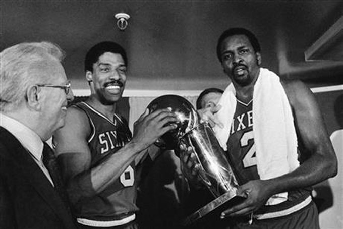  In this Tuesday, May 31, 1983 file photo, Philadelphia 76ers Julius Erving, left, and Moses Malone, right, hold the NBA Championship trophy after defeating the Los Angeles Lakers in Los Angeles. Malone, a three-time NBA MVP and one of basketball’s most ferocious rebounders, died Sunday, Sept. 13, 2015, according to a The Philadelphia 76ers statement. He was 60. (AP Photo/File)