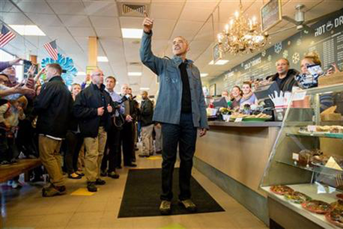 President Barack Obama speaks during a visit to the Snow City Cafe in Anchorage, Alaska, Tuesday, Sept. 1, 2015. Obama is on a historic three-day trip to Alaska aimed at showing solidarity with a state often overlooked by Washington, while using its glorious but changing landscape as an urgent call to action on climate change. (AP Photo/Andrew Harnik)