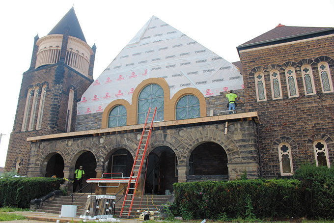 THE OUTSIDE OF THE CHURCH— Crew members of Liokareas Construction Company work on the exterior of the church. (Photos by J.L. Martello) 